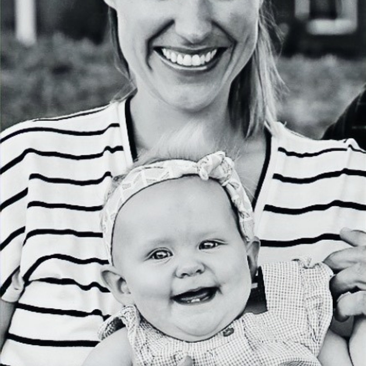 Alaina Clunas, lactation consultant and craniosacral therapist, smiling with a baby
