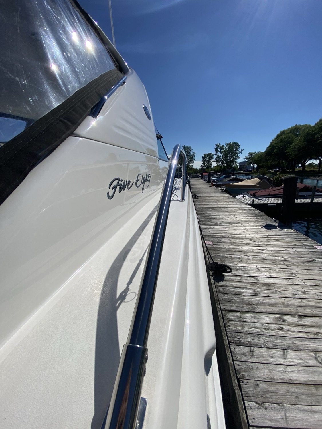 Glossy boat at a marina after professional detailing by AA Detailing