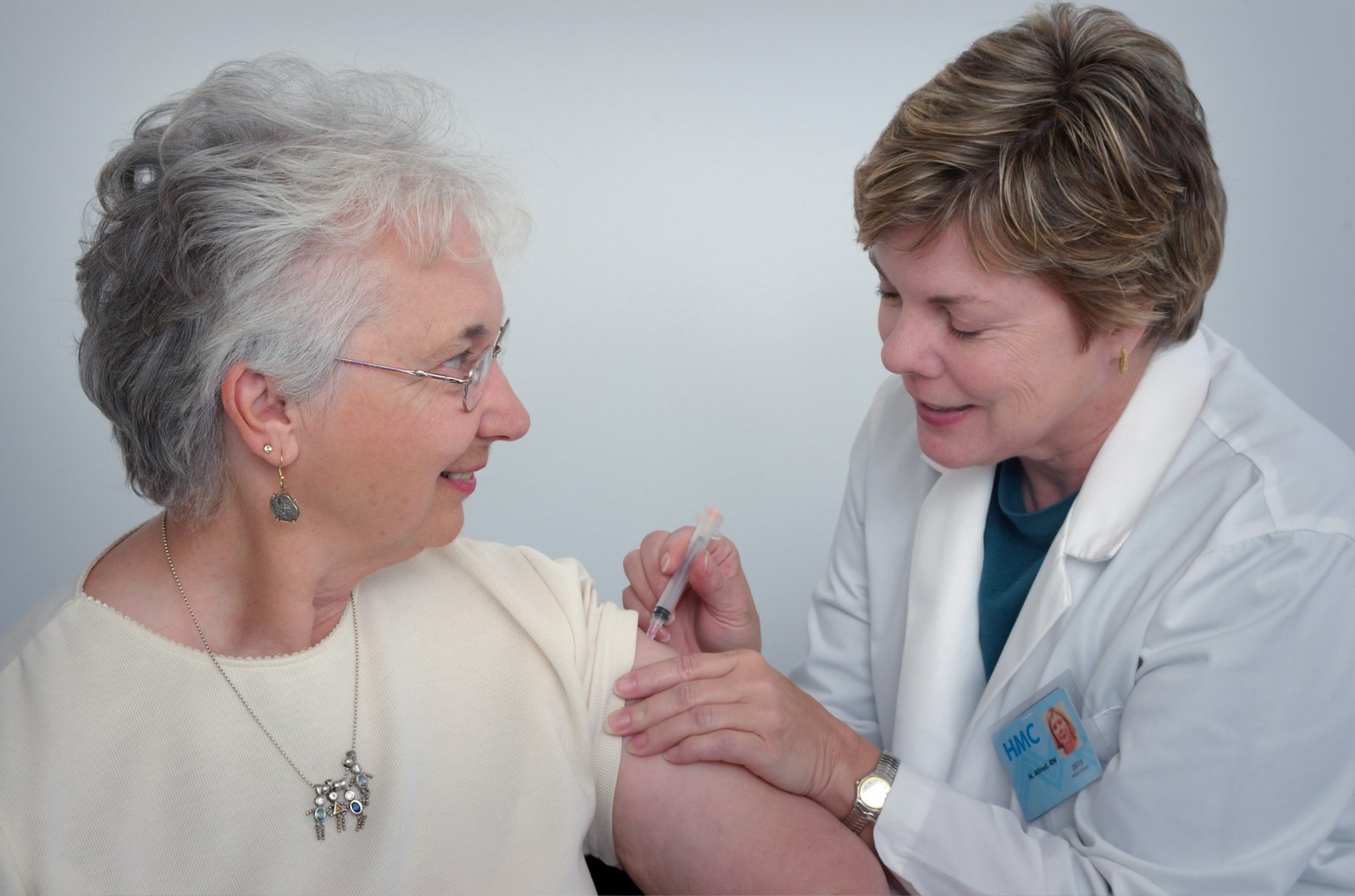 An audiologist fitting and tuning a hearing aid at Bentley Hearing Services