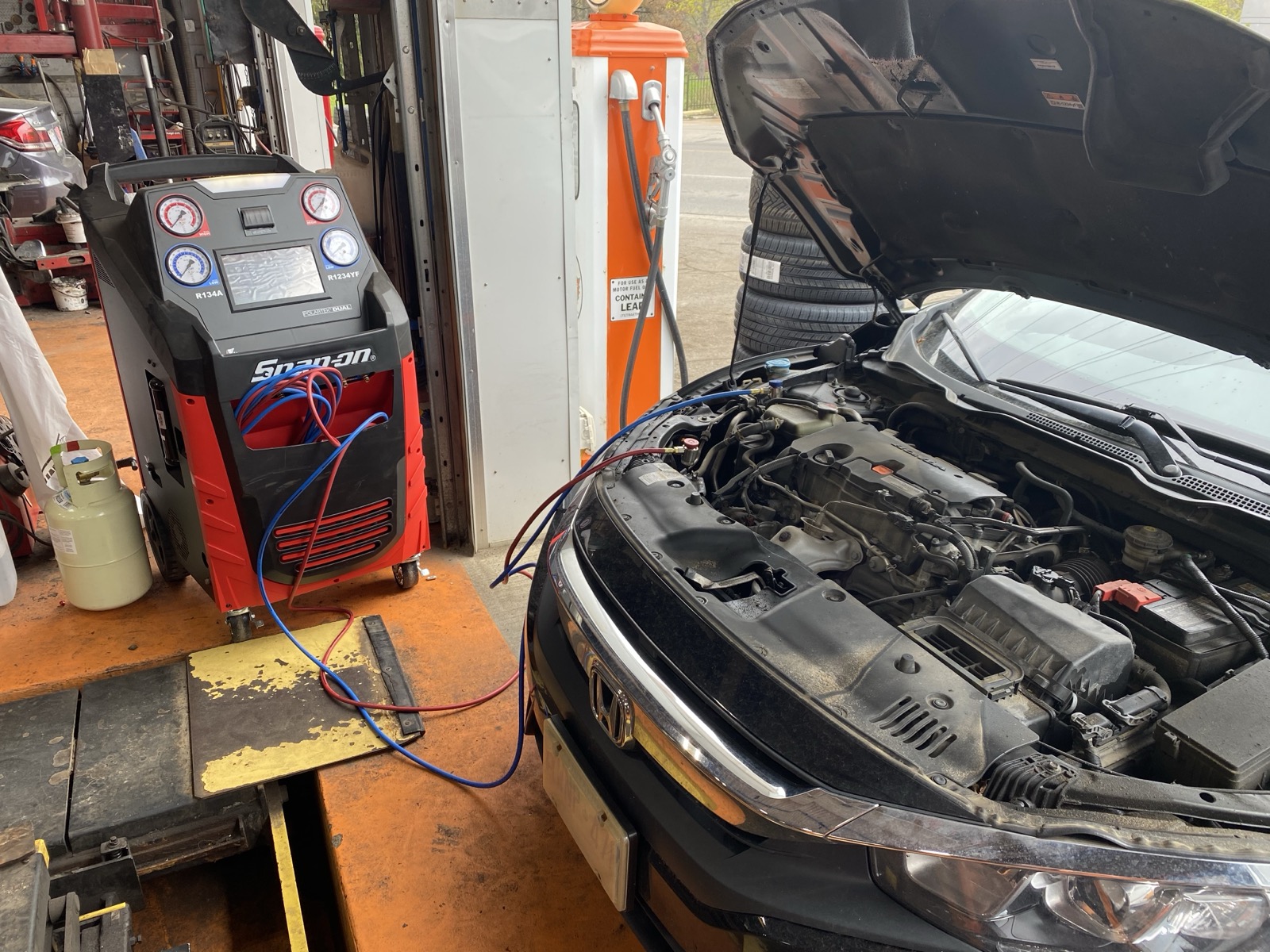 Snap-on diagnostic and A/C equipment servicing a vehicle in the bay at Byron Automotive