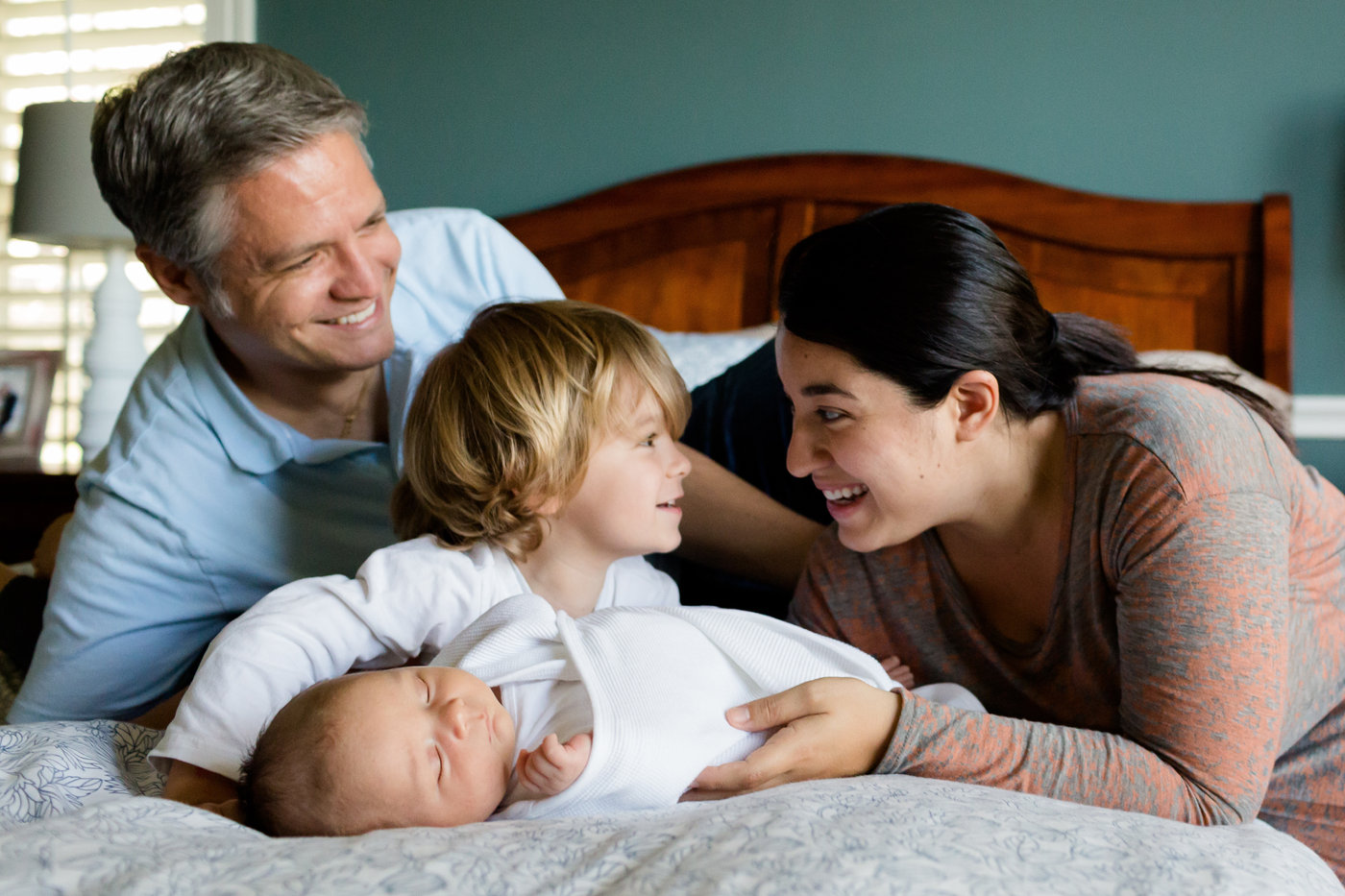 Parents and toddler with a newborn baby
