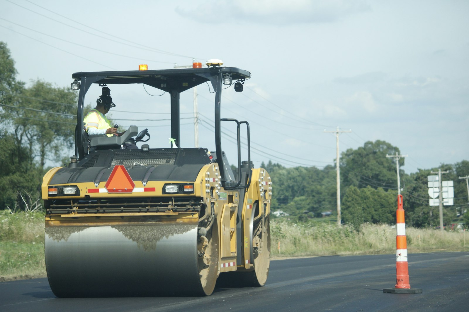 Roller compacting fresh asphalt on a CraftWell Group job in London Ontario