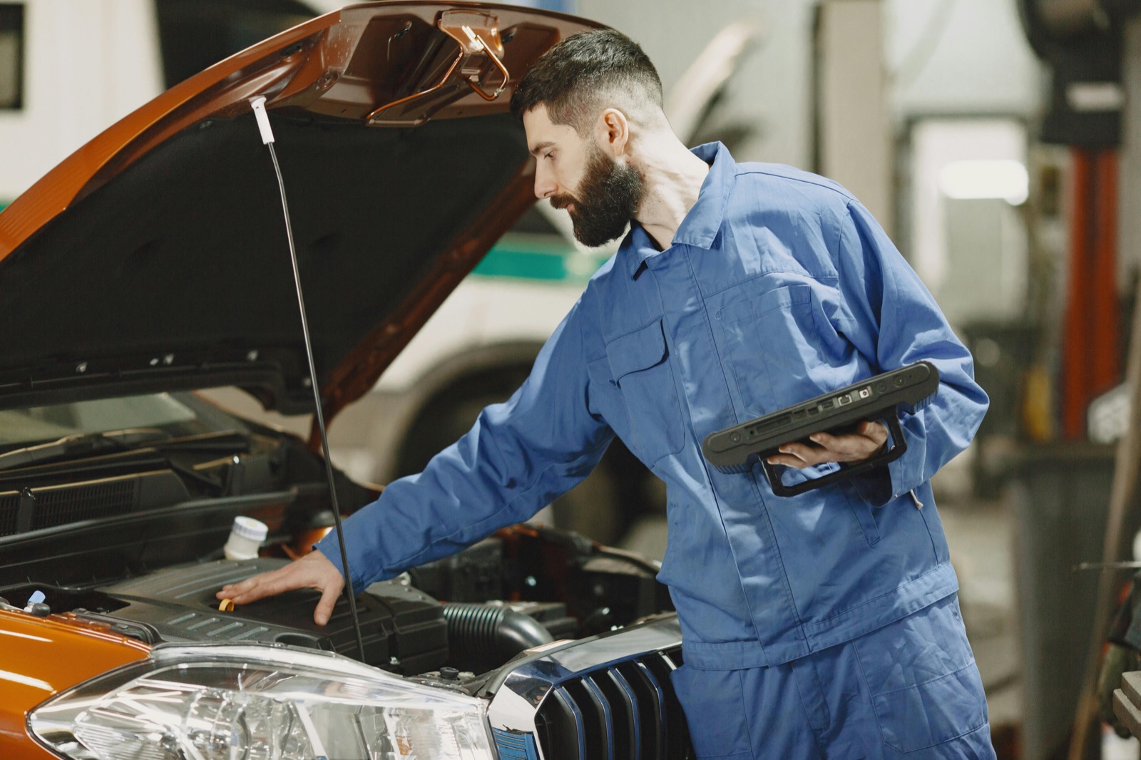 Mechanic using a diagnostic tablet at Lambeth Service Centre