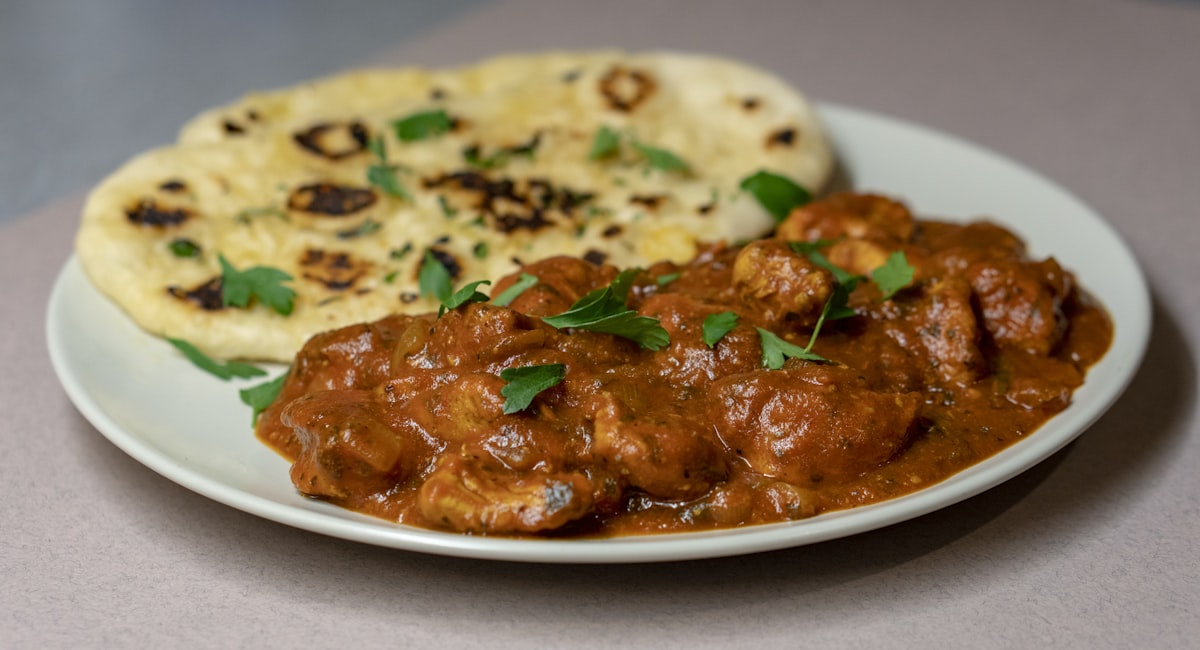 Massey's butter chicken simmered in a buttery tomato cream sauce, served with fresh naan