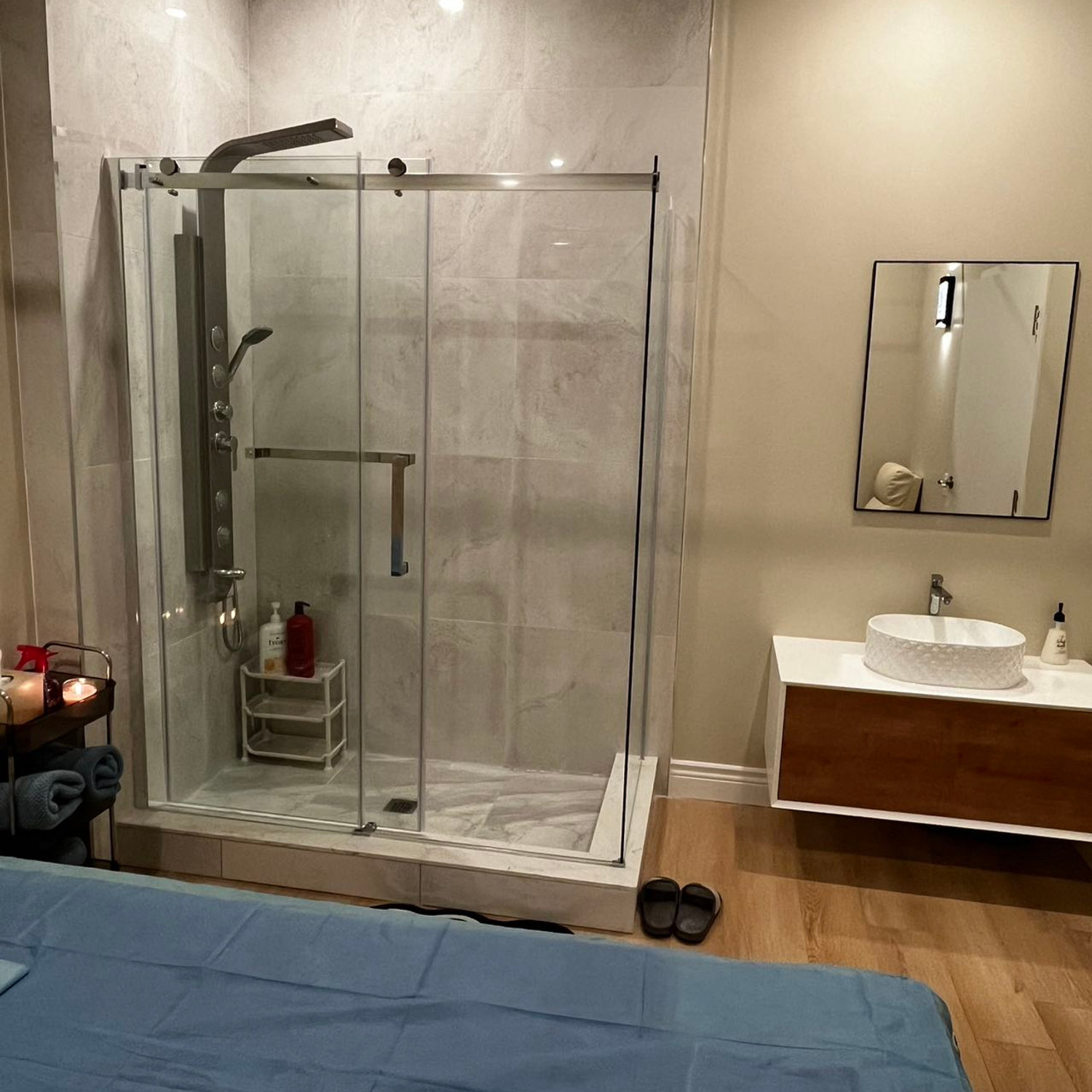 A peaceful massage room interior with warm light and a table set for treatment