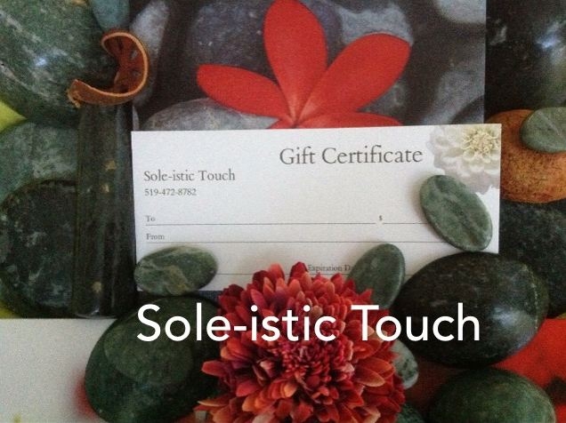 Jade river stones with a red plumeria flower and a Sole-istic Touch gift certificate