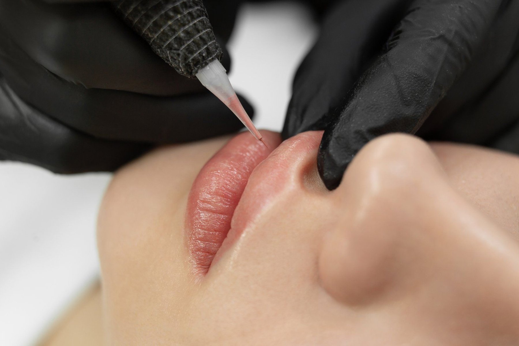 Lip permanent makeup being applied