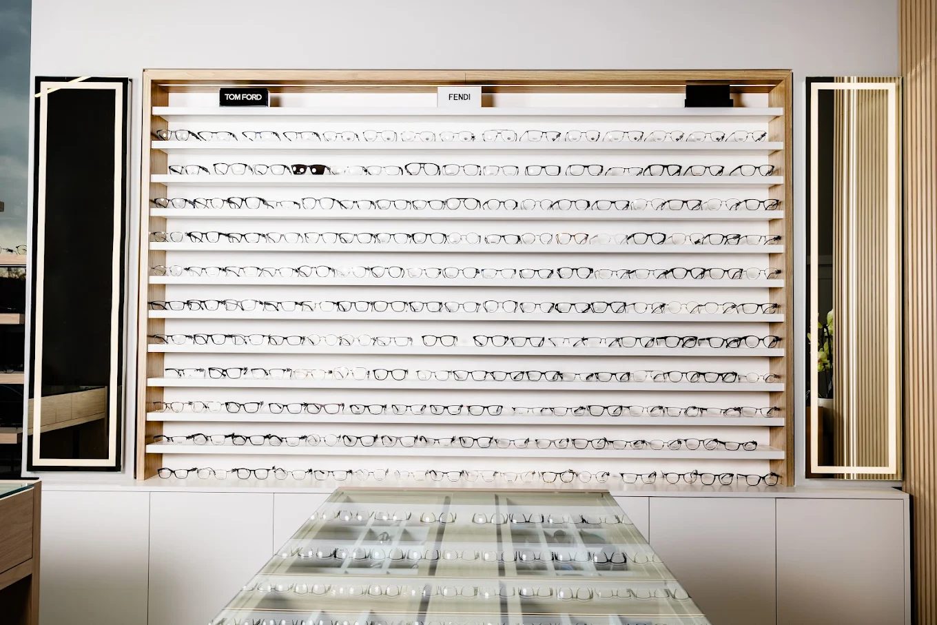 Inside the Squints Optical showroom, designer frames lining the wall, London Ontario