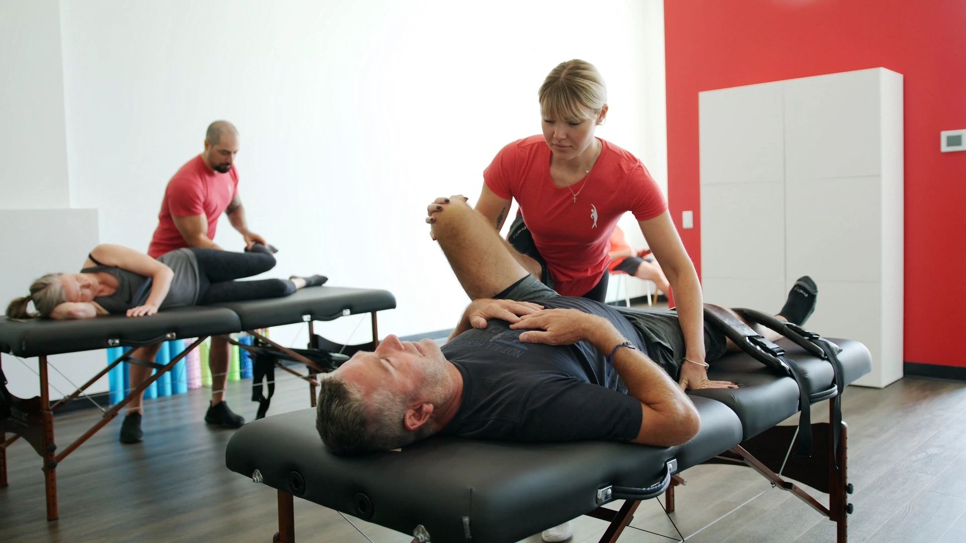 A Stretch Health therapist assisting a client through a guided stretch in the London studio