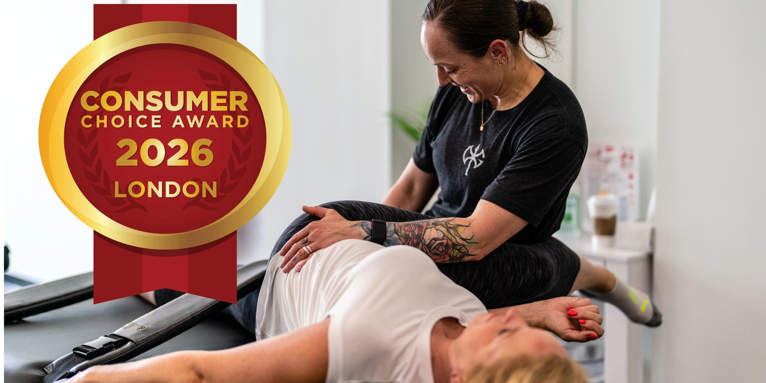 Stretch therapist in red SHC shirt working on a client at the London clinic, with the 2026 Consumer Choice Award badge
